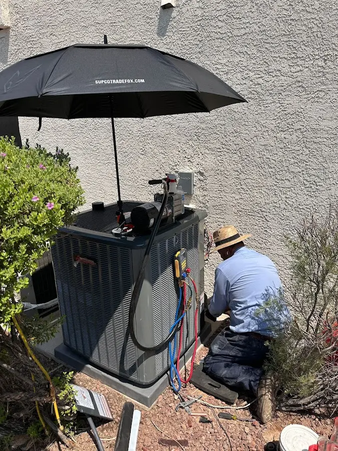 HVAC technician performing outdoor AC maintenance in Longwood