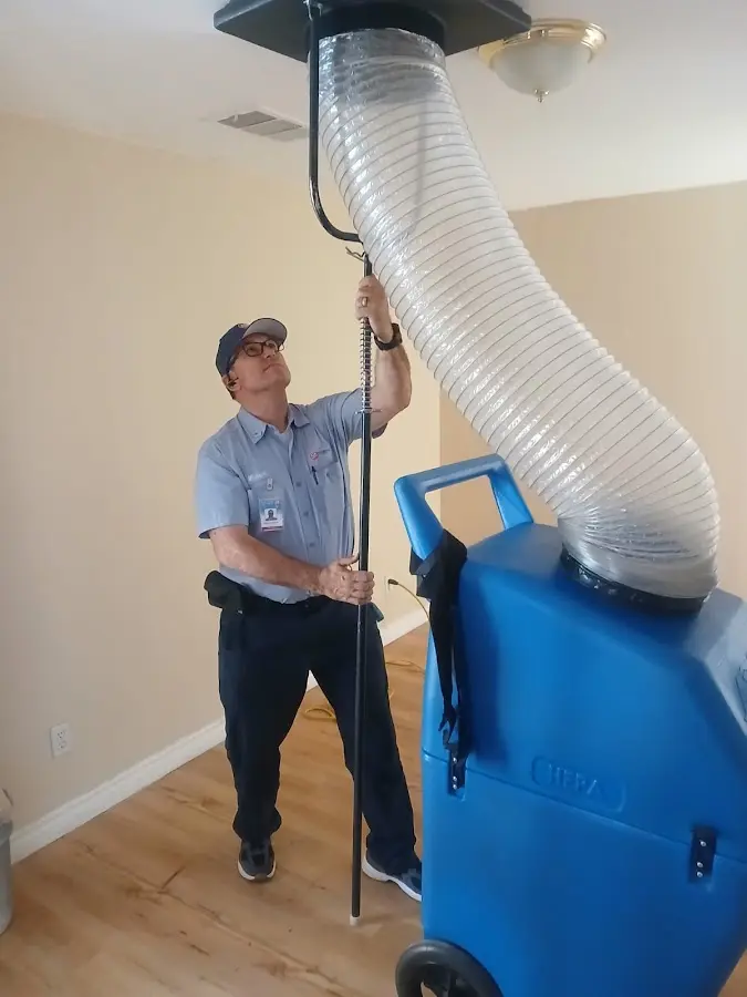 Furnace Tune-Up technician using HEPA equipment in Longwood